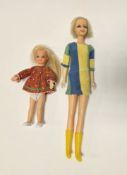 Mattel Twiggy Barbie doll, circa 1967, wearing a blue, green and yellow striped dress and yellow