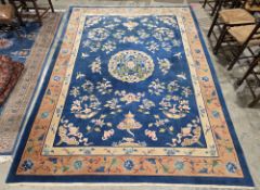 Chinese blue ground superwash wool carpet with central geometric medallion on field depicting