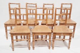 Set of seven French-style pine dining room chairs, having solid seats on ringed turned front legs,