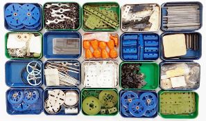 Quantity of Meccano parts in tins to include Pulleys, Brackets, Girders, curved strips, springs,