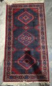 German midnight blue ground rug with three hooked hexagonal medallions, geometric spandrels and