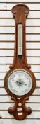 19th century rosewood and mahogany cased banjo shaped wheel barometer, the scrolling moulded frame