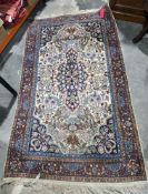 Large Persian style cream ground rug with central floral motif on floral and stylised bird field,