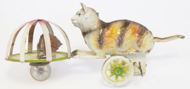 Tinplate clockwork toy featuring cat chasing a mouse in a dome on wheels (one missing) with integral