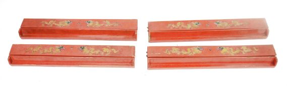 Set of four Chinese red lacquered mah-jong tile racks, the lids decorated with two gilt and coloured