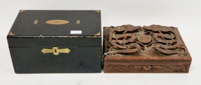 Chinese hardwood box, the lid carved in raised pierced relief with two dragons having red glass eyes