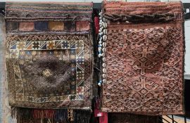 Two saddle bags, one with central lozenge on geometric field with multiple geometric border, 142cm x