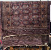 Eastern red ground rug with three rows of eleven hooked elephant foot guls and two rows of ten