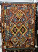 Chobi green ground kilim with two rows of three stepped lozenge medallions, multiple geometric