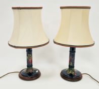 Pair of Moorcroft blue ground pomegranate pattern column-shaped table lamps, electrified, 23 cm.