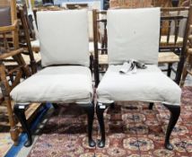 Pair of French style side chairs with upholstered backs and seats, on black finished cabriole legs