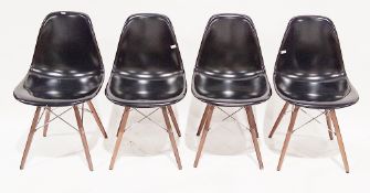 Set of four Eames DSW dining chairs, having black plastic seats, turned wooden legs and chrome-