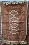 Silk cream ground rug with three central hooked lozenge medallions on geometric field with