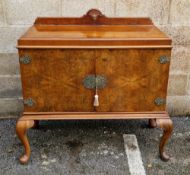 Figured walnut side cabinet, having pierced metal mounts, escutcheon and brackets, on cabriole