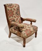 Late 19th / early 20th century oak opened framed armchair, upholstered in a floral patterned