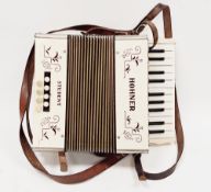 Hohner student accordion, cream cased with purple text, 28cm wide, cased Condition Report All keys