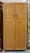 Mid-century Ercol Windsor range elm wardrobe, the two panel doors with oval moulded handles