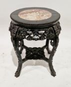 Chinese ebonised hardwood stand, of round form, the inset marble top over foliate carved and pierced
