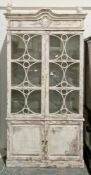 Modern glazed bookcase in the 19th century French style with a distressed white finish, the