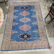 Large blue ground rug with five central geometric medallions, multiple geometric borders 280cm x