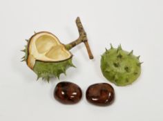 Contemporary porcelain trompe l'oeil model of a horse chesnut double conker in shell with lid,