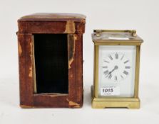 Brass cased striking carriage clock with bevelled glass panels, the white face with Roman