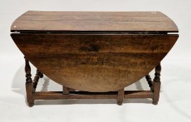 Antique oak gateleg dining table with oval top, baluster turned uprights and wheel turned