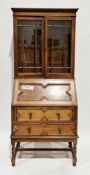 Early 20th century oak bureau bookcase, the upper section with two glazed doors opening to two