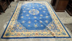 Chinese blue ground superwash carpet with central floral medallion, floral field and spandrels,