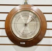 Early 20th century circular oak cushion framed wall barometer by Thomas Armstrong & Brother, no. 913