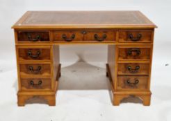 Yew wood twin pedestal desk in the George III manner, the rectangular top with brown leather inset