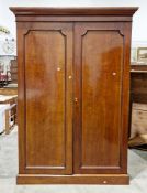 19th century mahogany wardrobe, the moulded cornice of two panel doors opening to two hanging