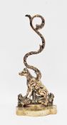 19th century brass and iron doorstop, cast in the form of a seated dog, with foliate scroll