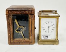 Brass cased striking carriage clock with bevelled glass panels, the white face with Roman