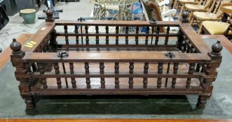 Indian hardwood hanging cot, with four wrought iron rings to top rail and turned spindle sides, 36cm