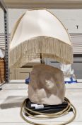A table lamp, the base with a faux marble effect bust of a woman, with fringed shade, 46cm high