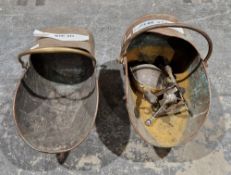 Two 19th century copper helmet shaped coal scuttles, together with a brass fireside trivet and two