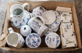 Collection of KLM Business Class ceramic drinks coasters together with other blue and white ceramics