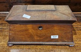 Regency rosewood tea caddy of sarcophagus form having two interior lidded compartments on squat