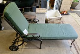 Aluminium framed garden lounger with green upholstered seat and back rest