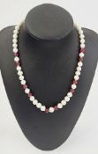 String of pearl and ruby faceted beads having ten faceted ruby beads, 43cm long approx