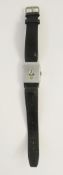 An Art Deco stainless steel jump hour watch with three dials to the rectangular face on black strap,