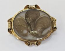 Early Victorian yellow metal mourning brooch of oval form, the front set with hair, in a Prince of