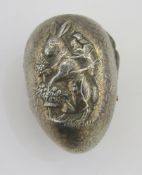 20th century white metal novelty Easter egg shaped trinket box, with embossed decoration of a rabbit
