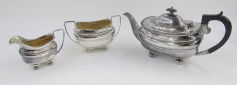 George V silver three piece tea set, comprising tea pot, milk jug and twin handled sugar dish, all