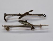 9ct gold bar brooch in the form of a fishing rod and reel, surmounted by a silver and enamel fish,