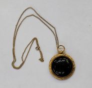 Victorian 9ct gold and onyx mounted pendant with engine-turned and scroll cast setting, with