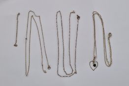 Three fine gold-coloured metal chains and a 14K yellow gold and green enamel heart-shaped pendant,