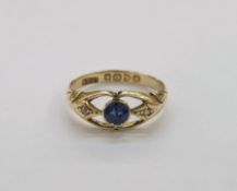 18ct yellow gold, sapphire and diamond ring comprising a central round mixed cut collet set sapphire