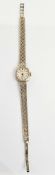 Lady's Caravelle 9 ct gold wristwatch with integral lattice pattern strap, 16.2 g total approx.
